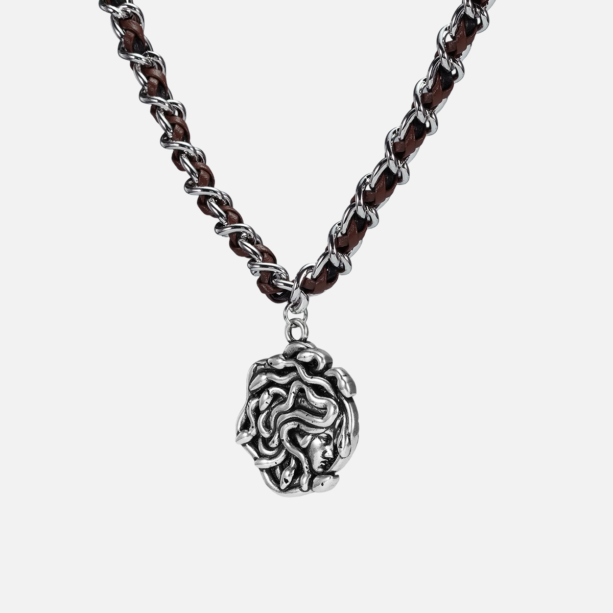 petrified power necklace in silver shown in an angled close-up view, featuring a medusa-inspired pendant on a braided chain