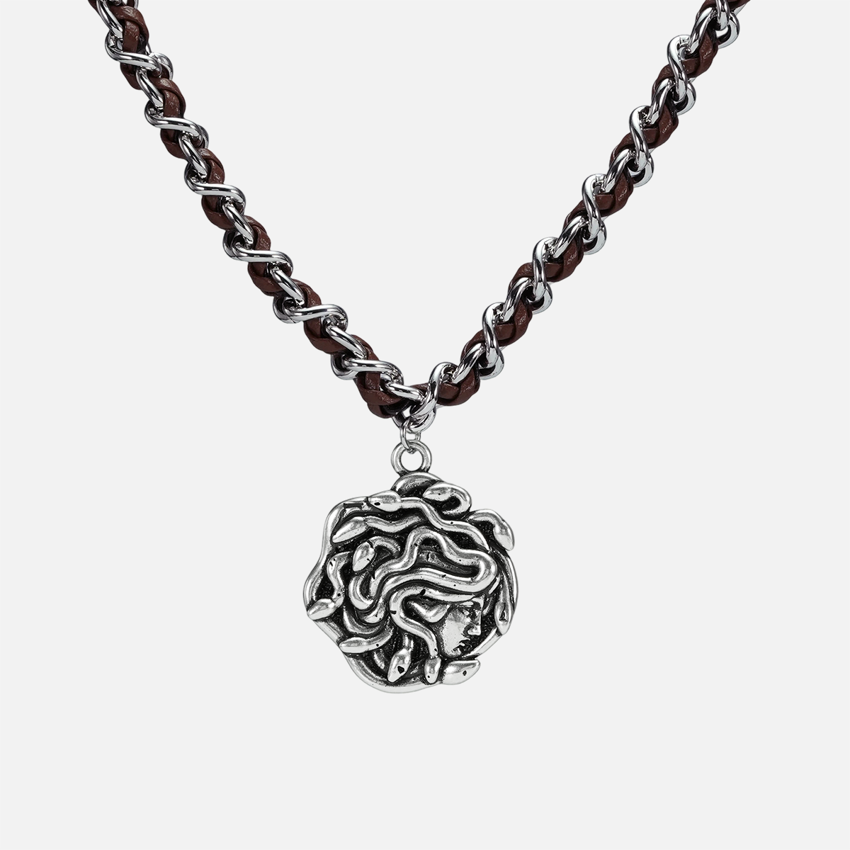 petrified power necklace in silver shown in a front close-up view, featuring a medusa-inspired pendant on a braided chain