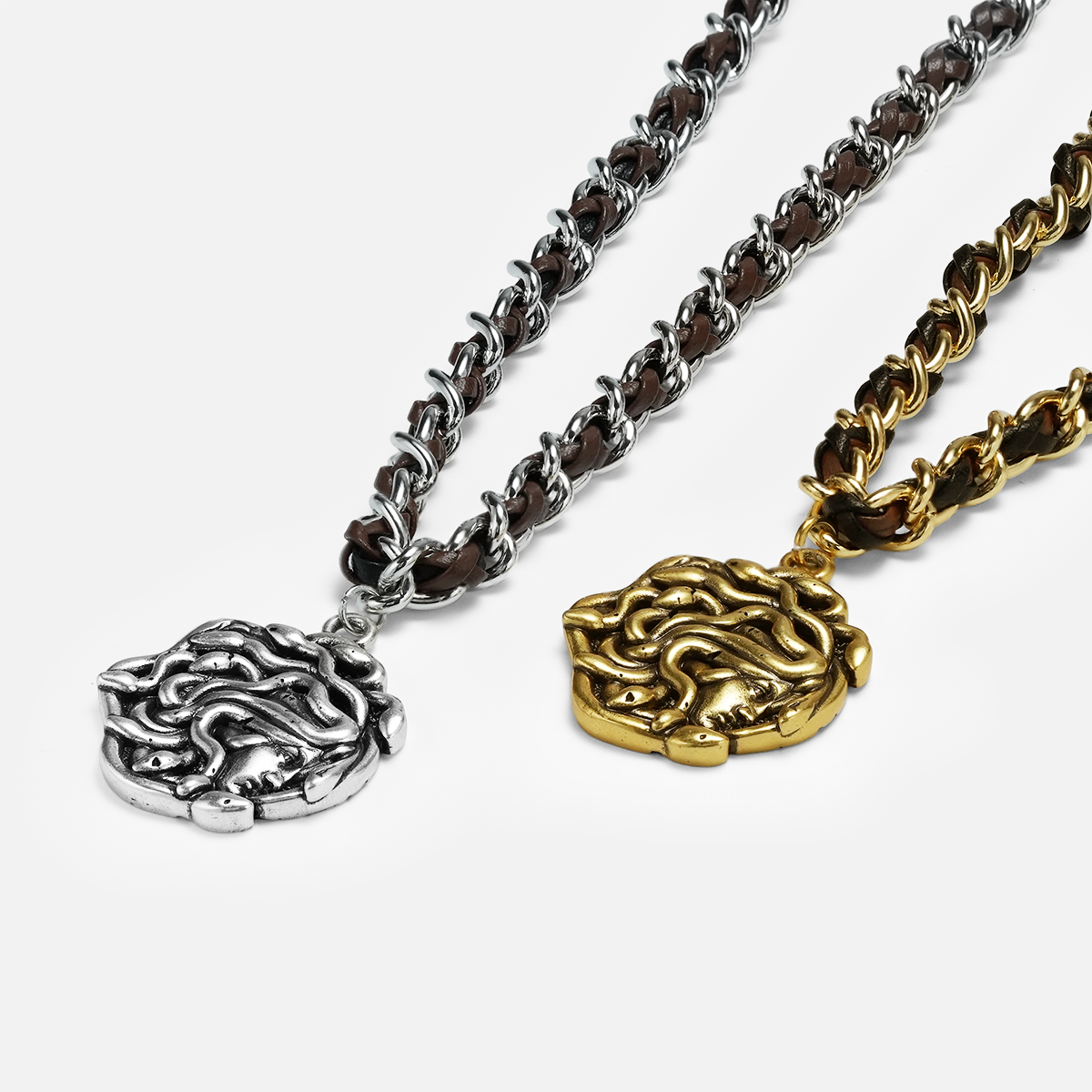 petrified power necklace shown in silver and gold in a close-up product view, featuring medusa-inspired pendants on braided chains