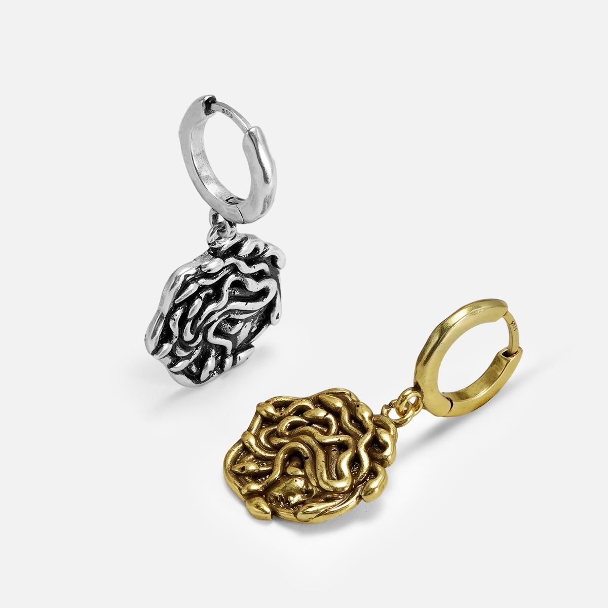 petrifying gaze dangle earrings shown in silver and gold in an angled view, featuring medusa-inspired dangle earrings with sculptural snake details