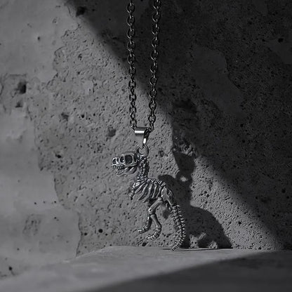 Silver Prehistoric Power necklace with dinosaur skeleton pendant on concrete