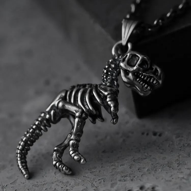 Two views of silver Prehistoric Power dinosaur skeleton pendant