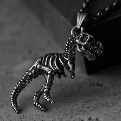 Two views of silver Prehistoric Power dinosaur skeleton pendant