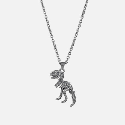 Silver-tone chain necklace with a dinosaur skeleton pendant shaped like a T-rex, laid flat