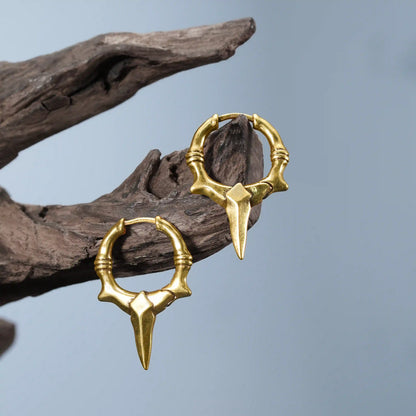 Gold Primal Blade Earrings displayed on driftwood with sharp antiqued hoop silhouette