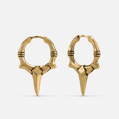 Primal Blade Earrings in gold-tone brass with dagger blade hoop silhouette and antiqued finish