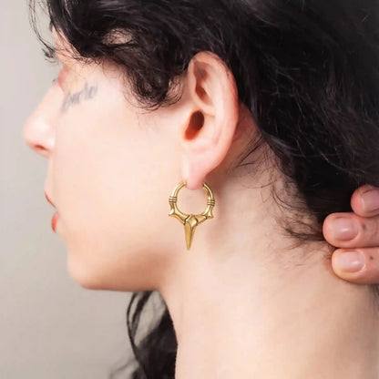 Gold Primal Blade Earrings styled on model with antiqued brass texture and blade point design