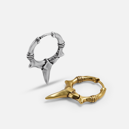 Primal Blade Earrings shown in silver and gold tones with dagger-shaped hoop design