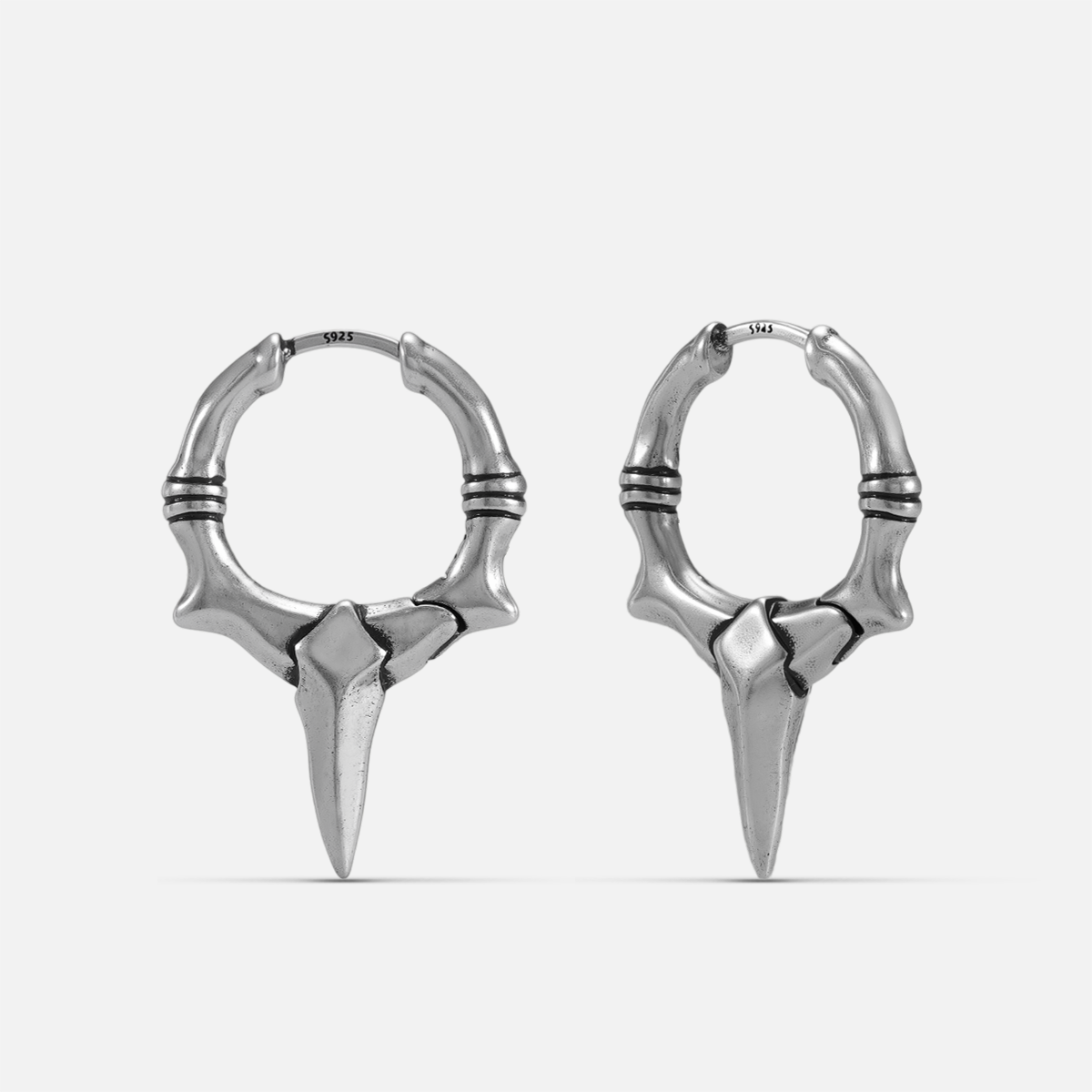Primal Blade Earrings in silver-tone brass with bone-textured hoops and sharp blade points