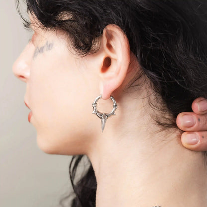Silver Primal Blade Earrings styled on model with sharp gothic hoop design