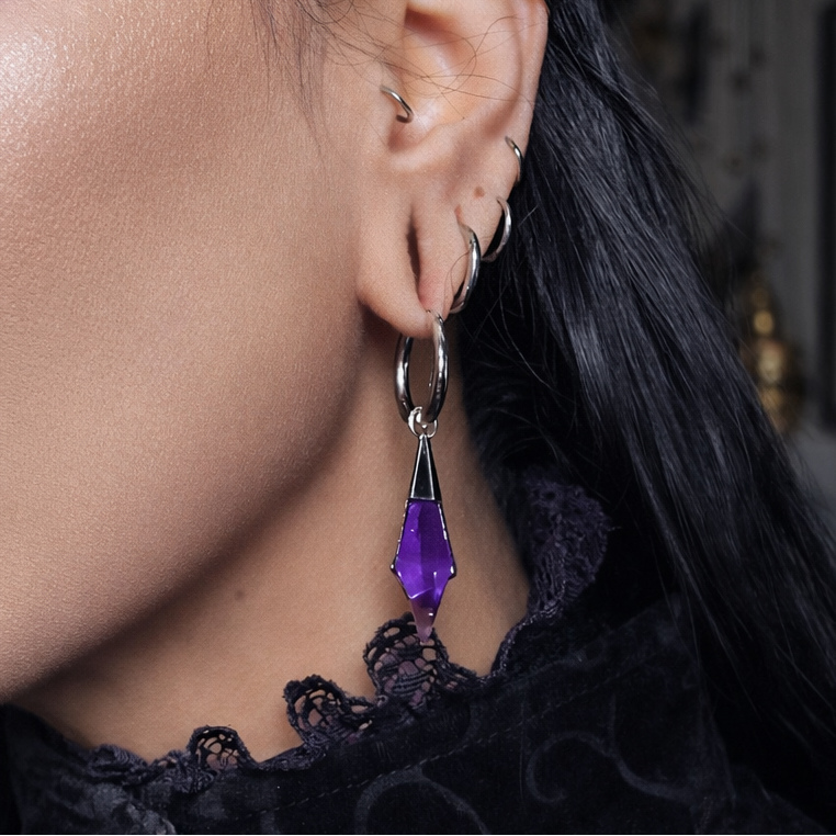 Model wearing the silver Prism Apex Earrings with amethyst crystal drops, shown with dark lace styling and gothic mood.