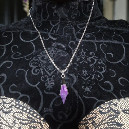 Silver-tone Prism Apex Necklace with a purple crystal pendant displayed on a black patterned jewelry bust.