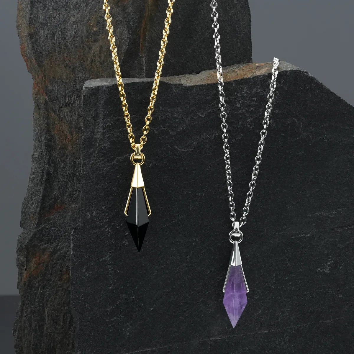 Silver- and gold-tone Prism Apex Necklaces displayed together, featuring purple and black crystal pendants.