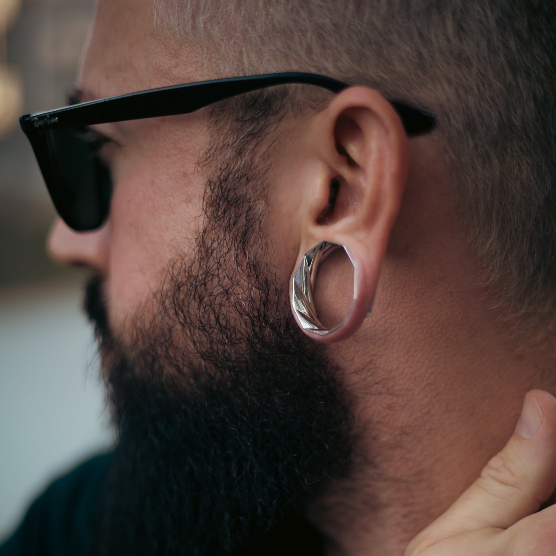 Side view of model wearing a silver Prismatic Harmony tunnel
