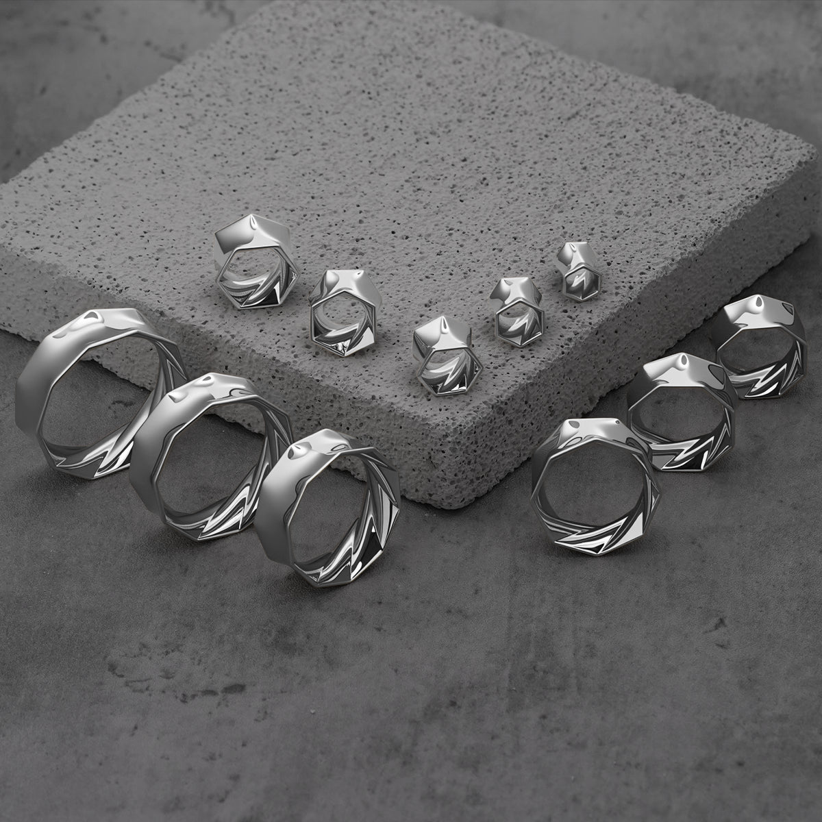 Silver Prismatic Harmony tunnels in graduated sizes arranged on gray blocks