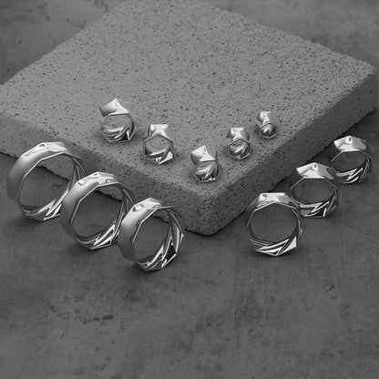 Silver Prismatic Harmony tunnels in graduated sizes arranged on gray blocks