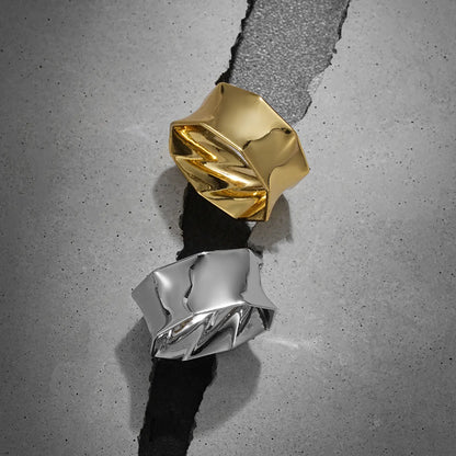 Large gold and silver Prismatic Harmony tunnels displayed on gray blocks
