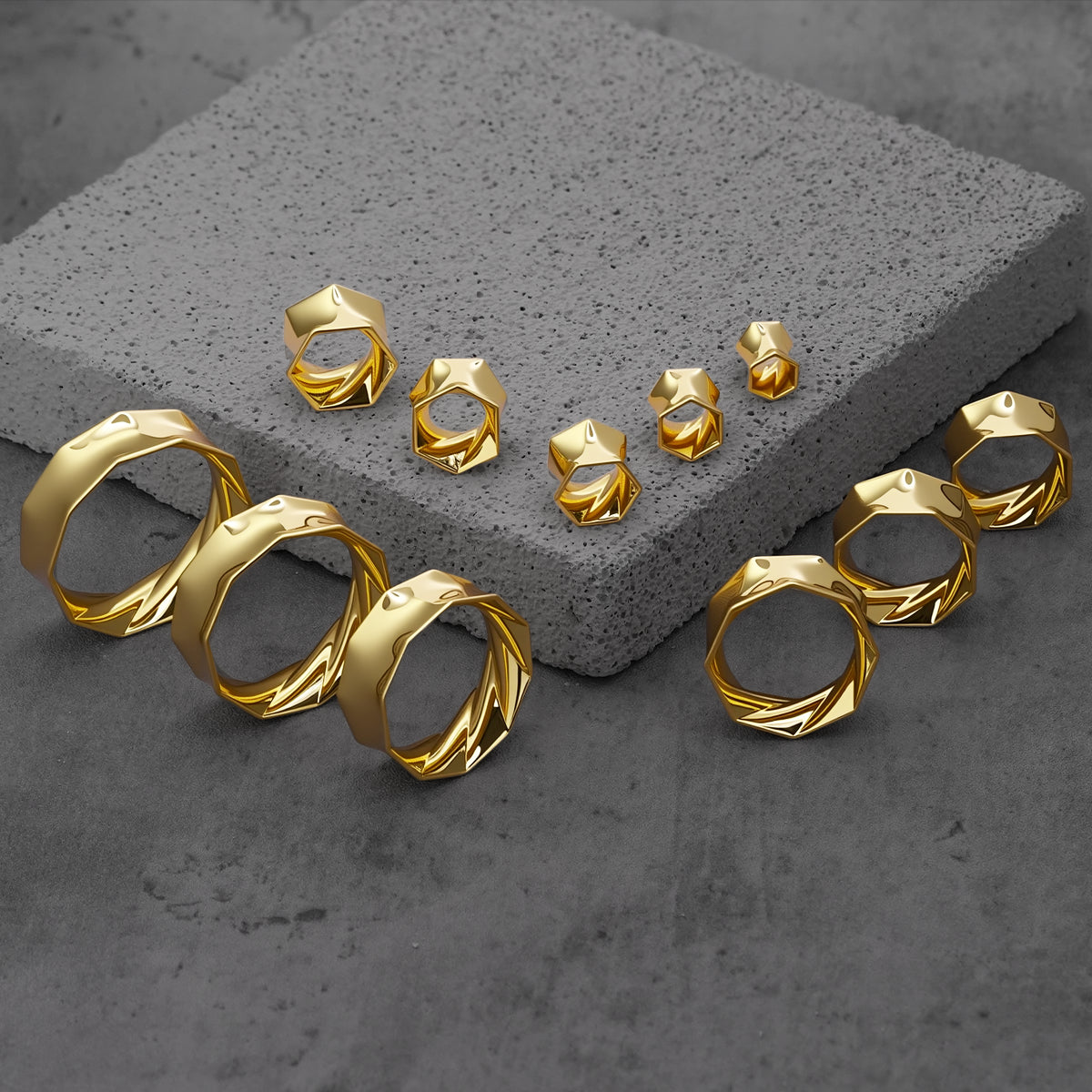 Gold Prismatic Harmony tunnels in graduated sizes arranged on gray blocks