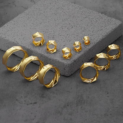 Gold Prismatic Harmony tunnels in graduated sizes arranged on gray blocks