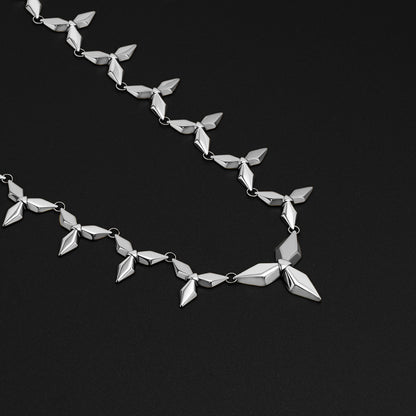 Silver Punk Petal necklace with matching stud earrings on black background