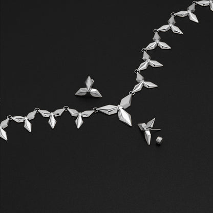 Silver Punk Petal necklace and stud earrings arranged on black background