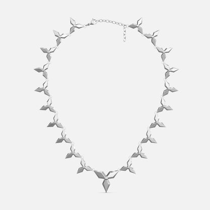 Silver-tone petal necklace with layered diamond-shaped links and a pointed pendant, laid flat