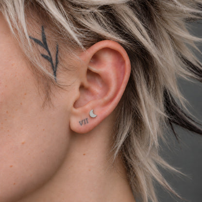 Crescent Titanium Flatback Stud worn alone on the approved ear model.