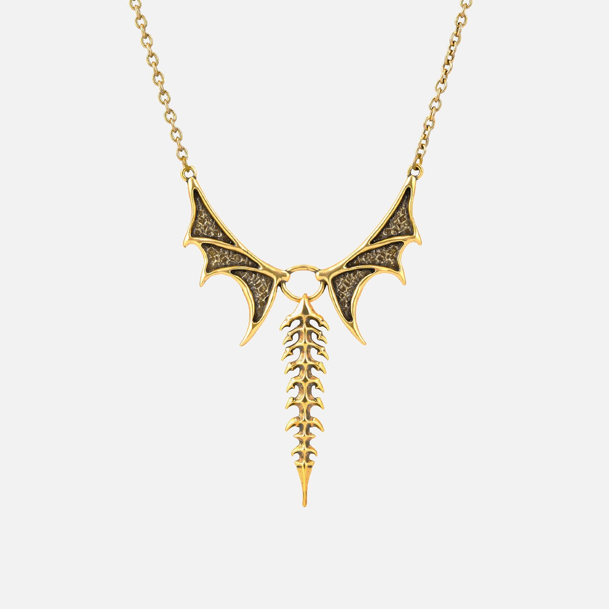 Punkyouth Nocturnal spine necklace in gold, featuring sculpted bat wings and vertebra-inspired drop pendant