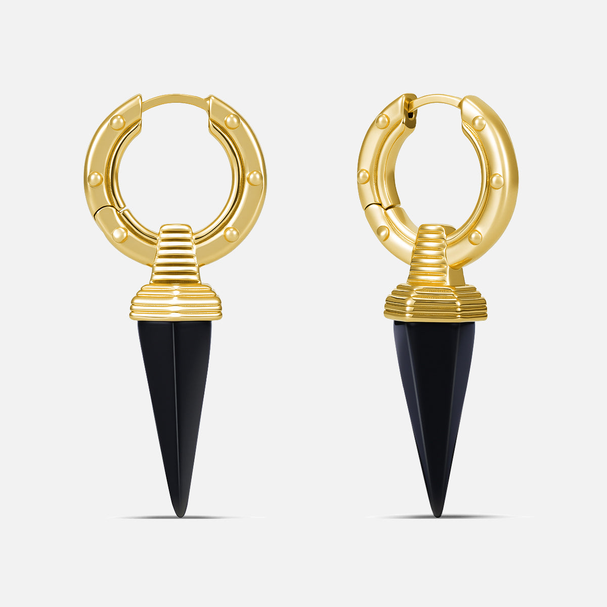 Punkyouth Ritual fang earrings in gold, featuring studded hoops and pointed fang pendants