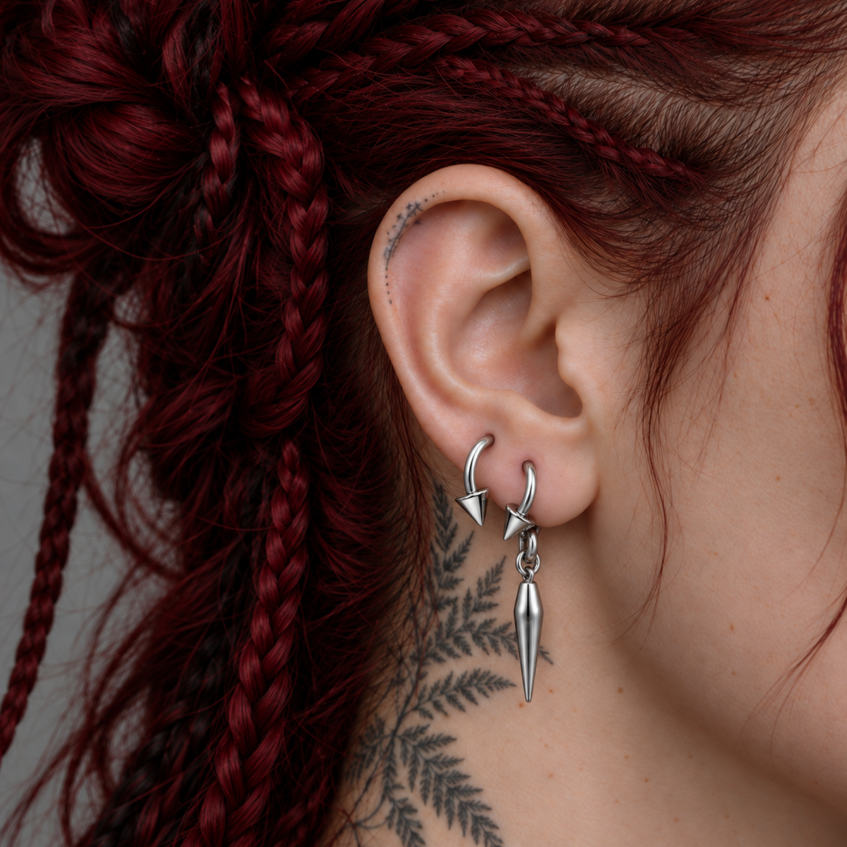 PUNKYOUTH Bone and twin spike ear stack: Twin Spike Horseshoe Ring + Ossuary Spike Hoop Earrings. Each jewellery design is sold separately.