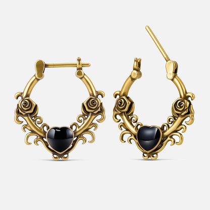 Punkyouth Thornheart earrings in gold, featuring sculpted roses and black heart-shaped resin centers