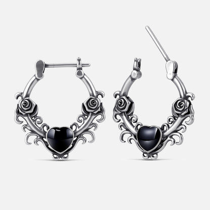 Punkyouth Thornheart earrings in silver, featuring sculpted roses and black heart-shaped resin centers