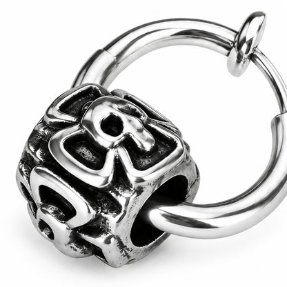Close detail of the cast openwork skull bead and the slim hoop passing through its side aperture.