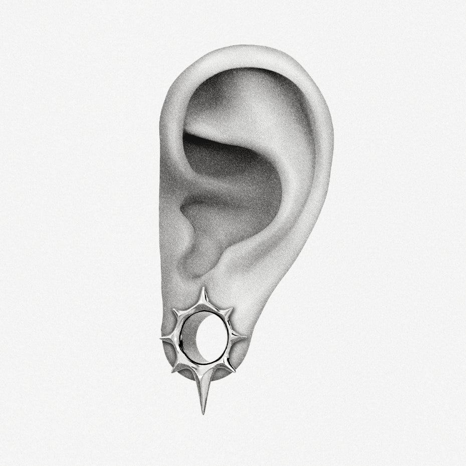 Illustration of an ear showing placement of a silver-tone star tunnel earring in the lobe