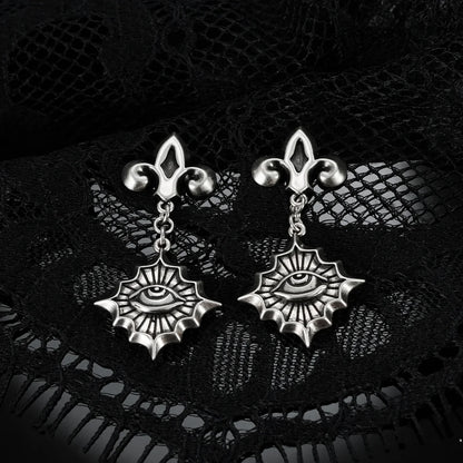Antiqued silver-tone Radiant Witness Drop Earrings displayed as a pair against black lace on a dark reflective surface.