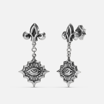 Antiqued silver-tone Radiant Witness Drop Earrings shown from front and side views with sculpted eye motifs, radiating pointed frames, and fleur-de-lis studs.