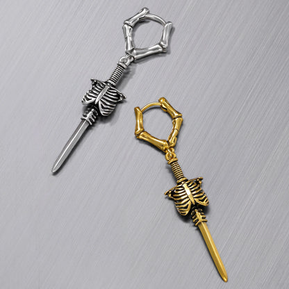 Silver-tone and gold-tone bone hoop earrings with ribcage and blade charms laid flat side by side
