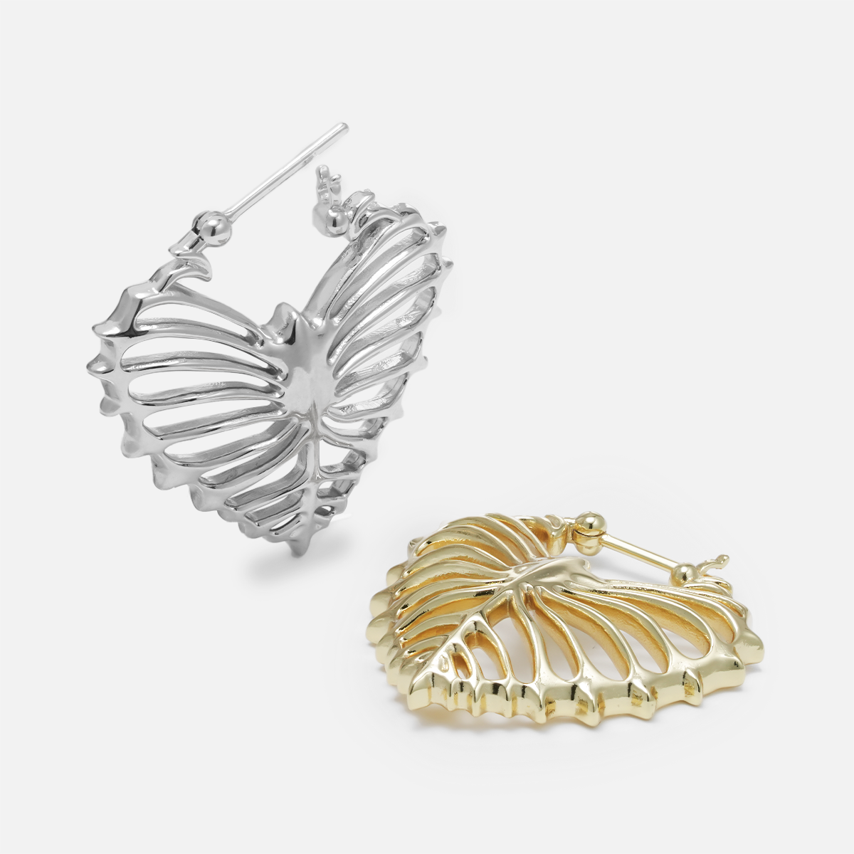 Silver and gold Ribheart earrings shown open and lying flat
