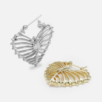 Silver and gold Ribheart earrings shown open and lying flat