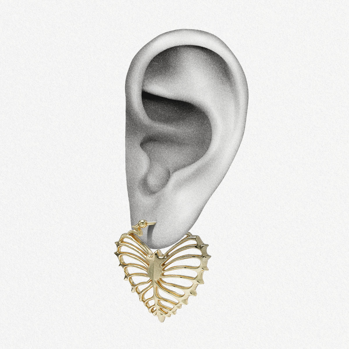 Gold Ribheart earring shown on an ear illustration