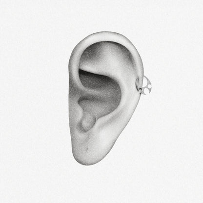 Silver Ritual Claw Clicker shown on ear placement with inward-flowing claw details