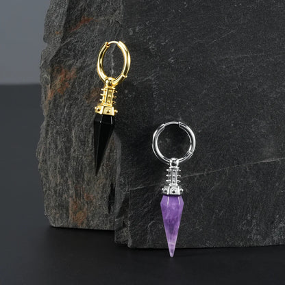 Silver and gold Rivet Prism Earrings displayed on a dark stone surface, showing faceted crystal spikes, studded collars, and industrial prism styling.