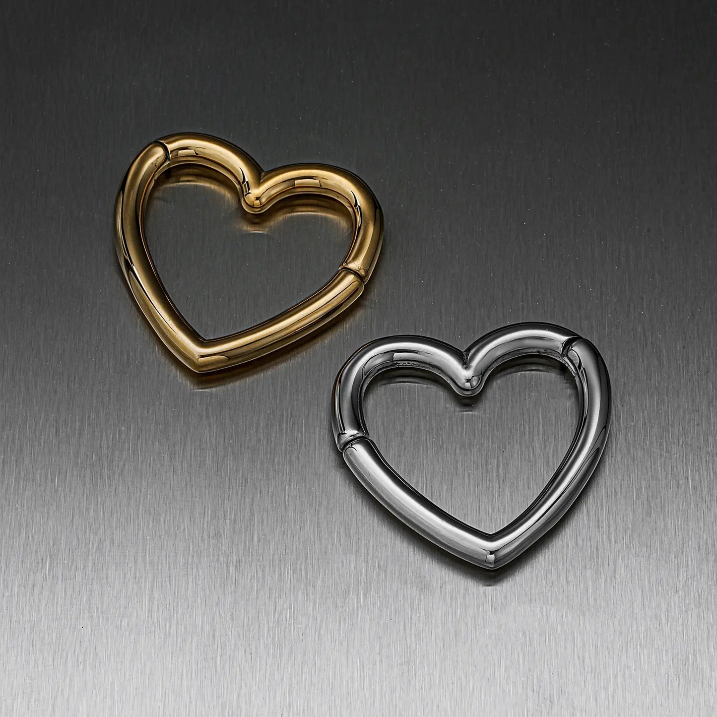 Heart-shaped hinged ear weights in gold-tone and silver-tone finishes, closed views