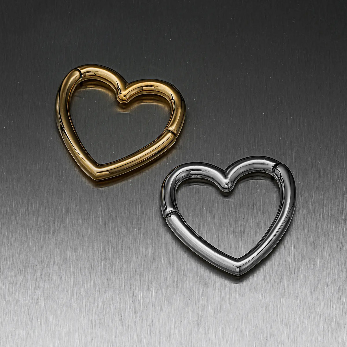 Heart-shaped hinged ear weights in gold-tone and silver-tone finishes, closed views