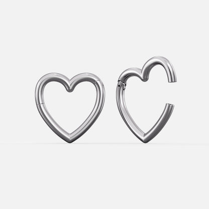 Silver-tone heart-shaped hinged ear weights, one closed and one open showing the clasp