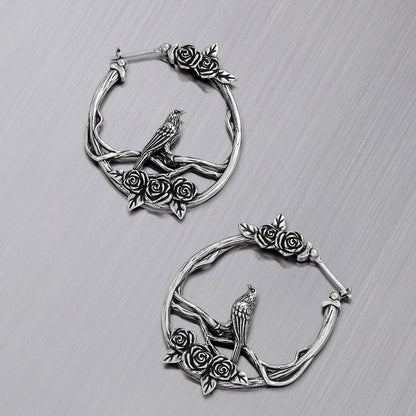 Pair of silver Rosebird hoop earrings shown open and closed
