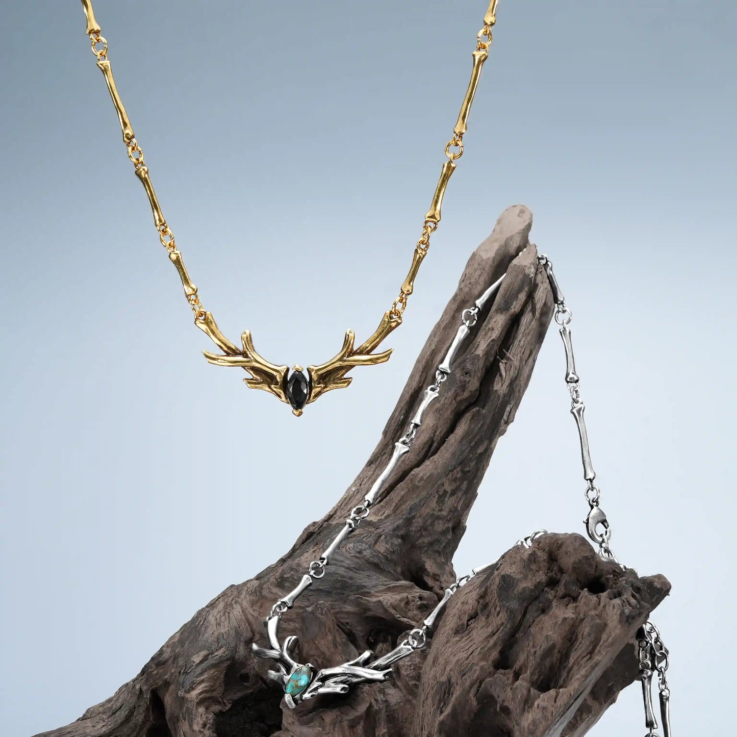 Sacred Antler Collar Necklace in gold and silver displayed on weathered wood with dark woodland styling