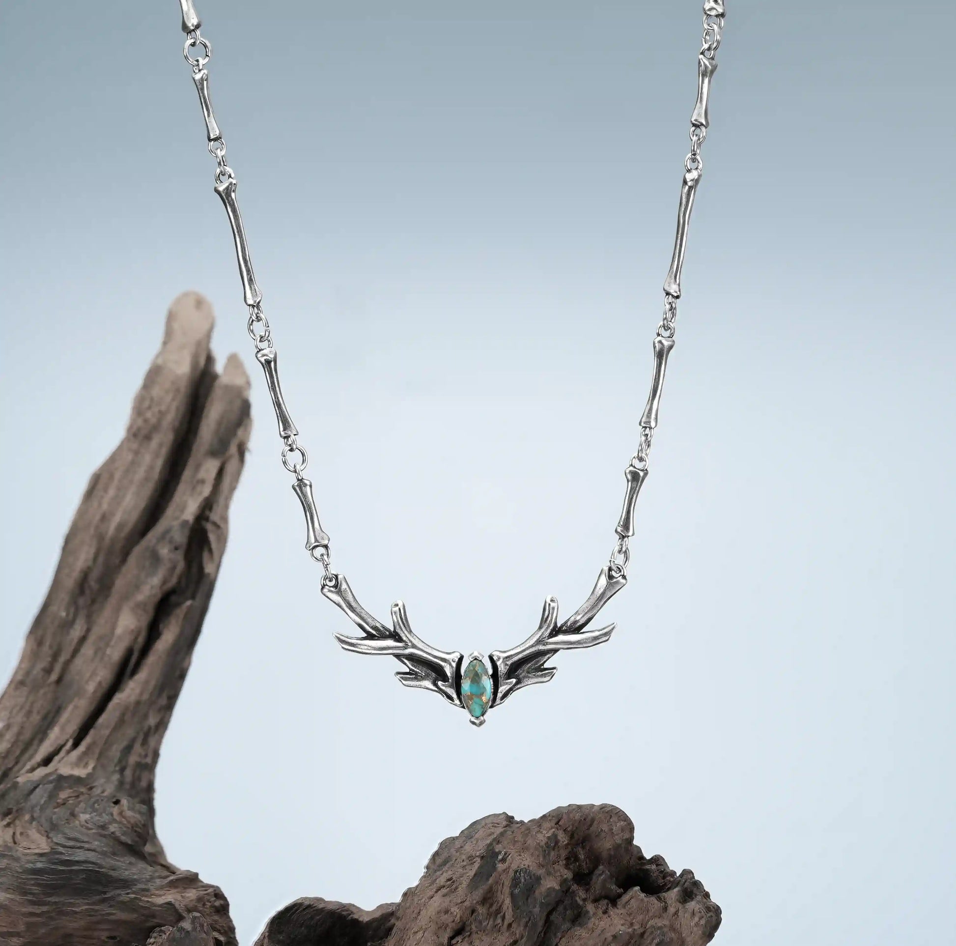 Silver Sacred Antler Collar Necklace displayed on driftwood with turquoise stone and woodland relic mood