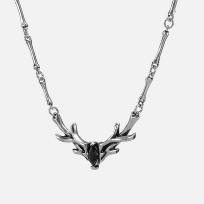 Close-up product view of the silver Sacred Antler Collar Necklace, featuring a black obsidian stone, sculpted antler centerpiece, and articulated chain design.