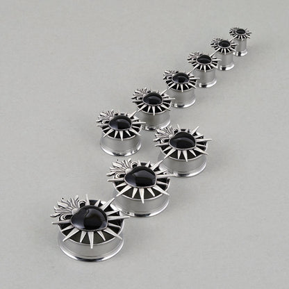 Sacred Flame Heart tunnels in graduated sizes arranged on a light surface